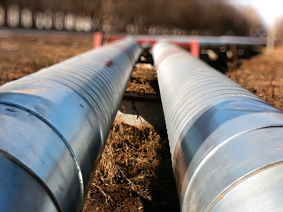 Two long sewer pipes above the ground